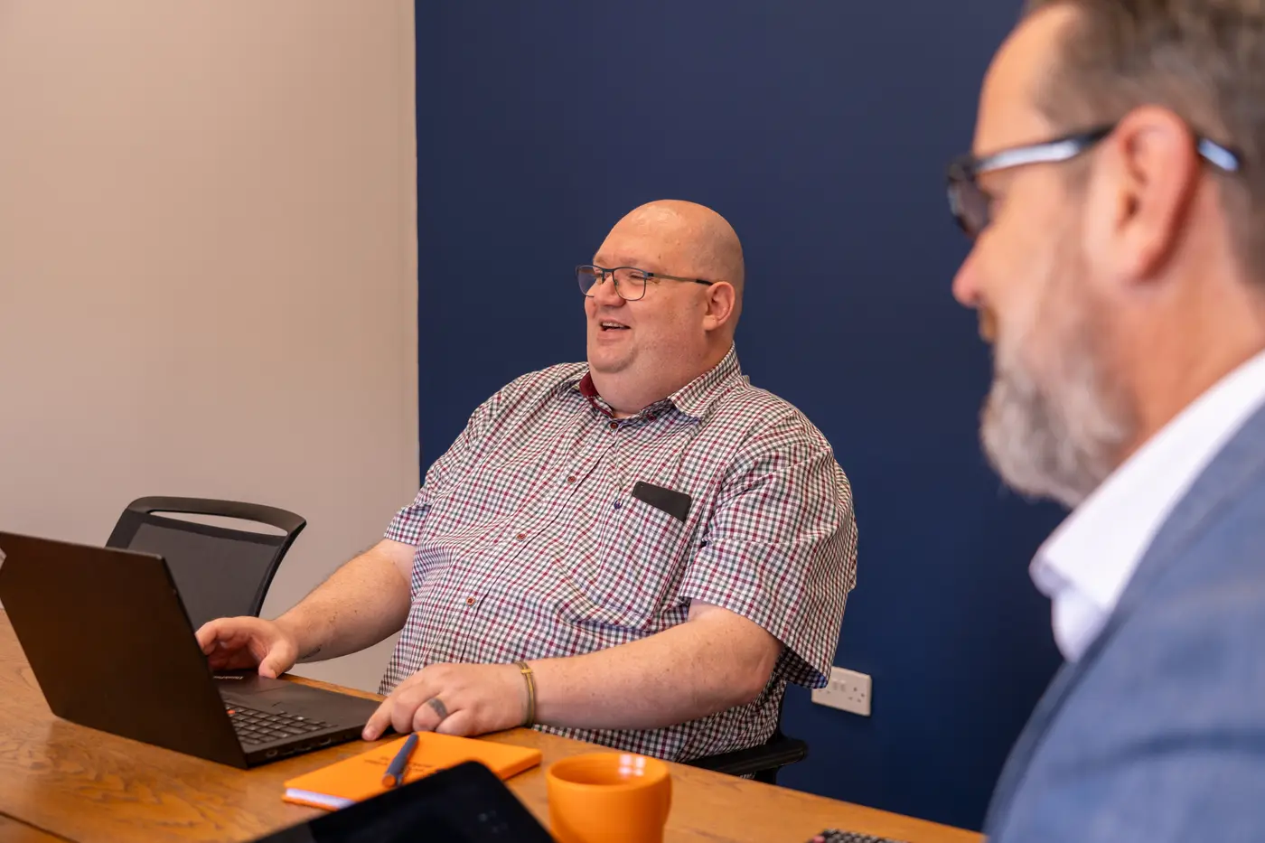 A colleague sharing a laugh in a team meeting