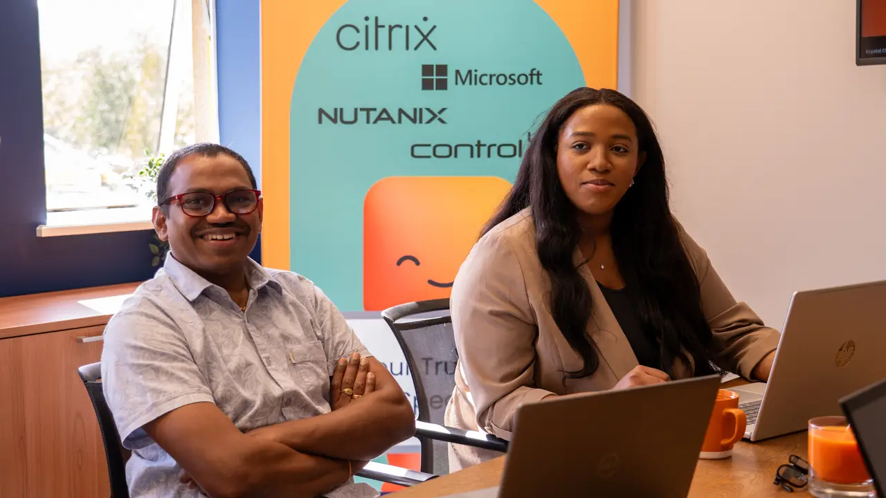 Two Enterprise Solutions engineers at a team meeting