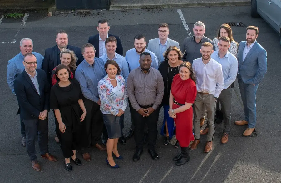 The expanded Enterprise Solutions team together outside the office