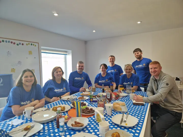 The team sharing breakfast in Aware t-shirts