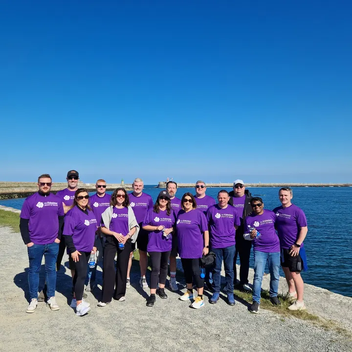 The team in purple Alzheimer Society t-shirts on the pier
