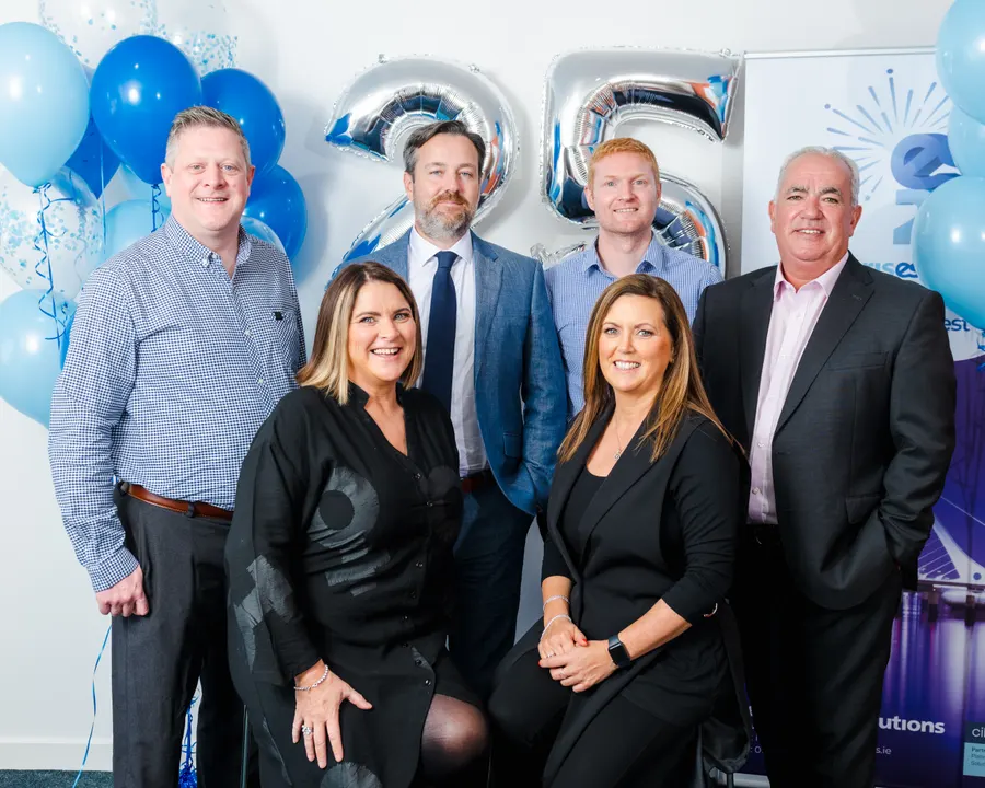 The leadership team celebrating 25 years with balloons