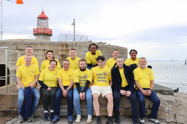 The team in yellow Irish Cancer Society t-shirts by the lighthouse