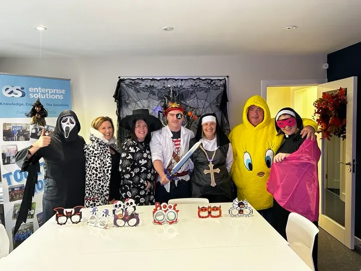 The team in Halloween costumes in the office