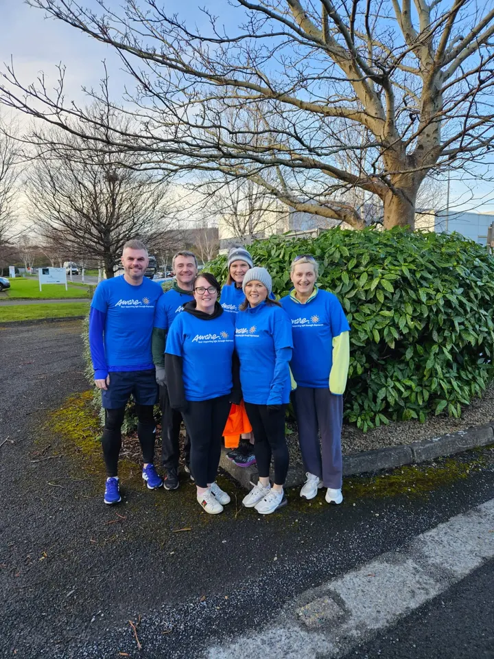 The team in blue Aware t-shirts in the park