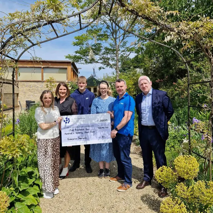 Presenting a cheque to the Alzheimer Society in the garden